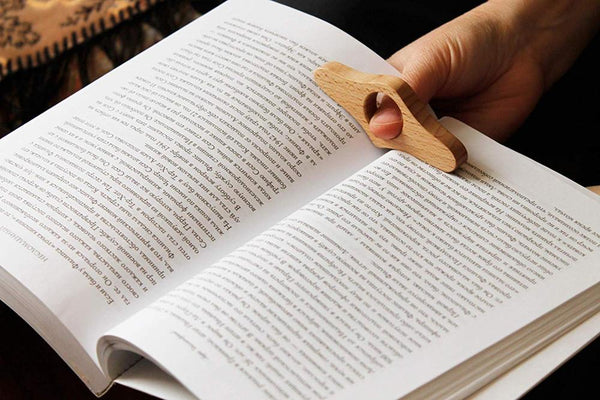 Thumb book page holder